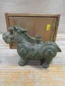 A VINTAGE BRONZE ORIENTAL CANDLE HOLDER IN THE SHAPE OF A MYTHICAL ANIMAL