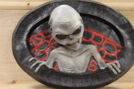 A LARGE SHOP DISPLAY OF AN ALIEN