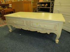 A LOW CREAM TWO DRAWER COFFEE TABLE