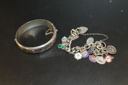 A SILVER CHARM BRACELET AND CHARMS TOGETHER WITH A HALLMARKED SILVER BANGLE (2)