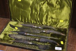 A CASED FIVE PIECE HORN HANDLED CARVING SET