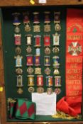 A DISPLAY CASE CONTAINING ROAB SASHES AND MEDALS RELATING TO RETFORD & DISTRICT KNIGHTS CHAPTER