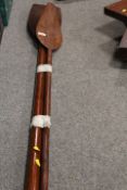 A TRIBAL STYLE PADDLE TOGETHER WITH ANOTHER