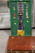 A DISPLAY BOARD CONTAINING ROAB SASHES AND MEDALS RELATING TO RETFORD & DISTRICT 1945 TOGETHER