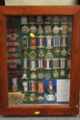 A DISPLAY CASE CONTAINING ROAB SASHES AND MEDALS RELATING TO RETFORD & DISTRICT 1992