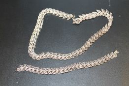A SILVER FILIGREE LEAF DESIGN NECKLACE AND BRACELET SET