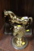 A BRASS MODEL OF A HORSE TOGETHER WITH A BRASS STUDY OF A HORSES HEAD