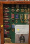 A DISPLAY CASE CONTAINING ROAB SASHES AND MEDALS RELATING TO RETFORD & DISTRICT 1993