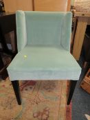 A MODERN UPHOLSTERED BEDROOM CHAIR