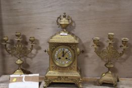 A GILT METAL THREE PIECE CLOCK GARNITURE
