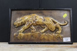 AN EARLY 20TH CENTURY GLAZED POTTERY TILE DEPICTING A JAGUAR IN PERIOD BLACK FRAME