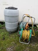 A 45 GALLON PLASTIC WATER BUTT TOGETHER WITH TWO HOSE PIPES ON REELS (3)