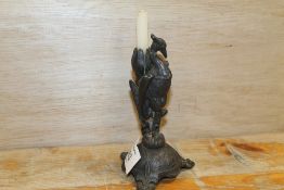 A SMALL VINTAGE METAL CANDLE HOLDER IN THE FORM OF A PHOENIX