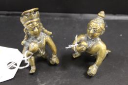A PAIR OF SMALL BRASS AZTEC STYLE BALL PLAYERS
