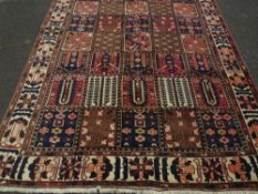 A LARGE BROWN GROUND PATTERNED WOOLLEN CARPET APPROX 312 X 205 CM