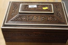 A CONTINENTAL CARVED WOODEN WRITING SLOPE