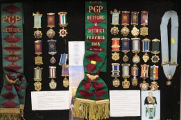 A LARGE DISPLAY CASE CONTAINING ROAB SASHES AND MEDALS RELATING TO RETFORD & DISTRICT 1980 & 1985