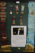 A DISPLAY CASE CONTAINING ROAB SASHES AND MEDALS RELATING TO RETFORD & DISTRICT 2012 AND