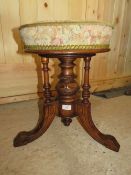 AN EDWARDIAN MAHOGANY CARVED REVOLVING PIANO STOOL