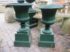 A PAIR OF GREEN PAINTED CAMPANA URNS ON PLINTHS, H 75 cm (2)