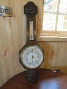 A 20TH CENTURY CARVED OAK ANEROID BAROMETER, H 79 cm
