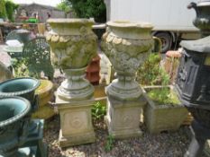A PAIR OF STONE FLORAL GARDEN URNS RAISED ON SQUARED PLINTHS, H 106 cm (2)
