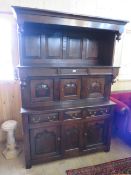 AN ANTIQUE OAK TRIDARN WITH THREE CENTRAL CUPBOARDS, THREE FRIEZE DRAWERS AND CUPBOARDS BELOW, H 198