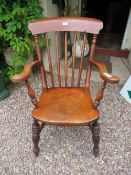 A TRADITIONAL ELM WINDSOR ARMCHAIR