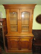 AN ANTIQUE STRIPPED TWO DOOR BOOKCASE, W 114 cm