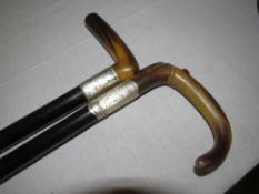 TWO SILVER COLLARED EBONISED WALKING CANES