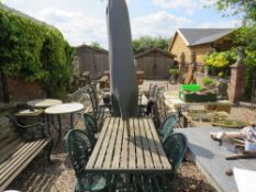 A GARDEN CAST AND WOODEN TABLE WITH FOUR GARDEN CHAIRS AND A PARASOL