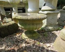 A STONE LOBED LOW GARDEN URN