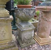 A STONE GARDEN URN ON A SQUARED PLINTH, H 72 cm