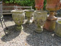 A PAIR OF STONE FLORAL URNS ON PLINTHS, H 66 cm (2)