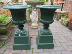 A PAIR OF GREEN PAINTED CAMPANA URNS ON PLINTHS, H 75 cm (2)