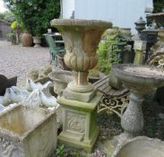 A GARDEN STONE CAMPANA STYLE URN RAISED ON A SQUARED PLINTH, H 101 cm