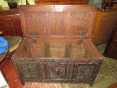 AN ANTIQUE CARVED OAK TRIPLE PANEL COFFER, W 122 cm