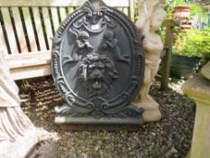 A LARGE OVAL CAST IRON PLAQUE, H 76 cm