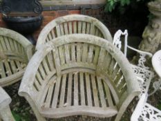 A PAIR OF CURVED HARDWOOD GARDEN ARMCHAIRS (2)
