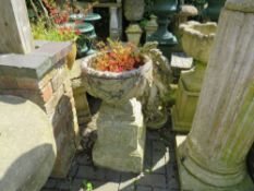A STONE GARDEN CIRCULAR URN ON PLINTH, H 73 cm