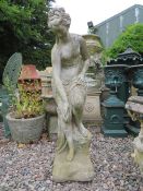 A STONE SEMI CLAD FEMALE GARDEN STATUE, H 90 cm