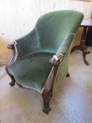 A VICTORIAN MAHOGANY FRAMED UPHOLSTERED ARMCHAIR WITH CARVED DETAIL