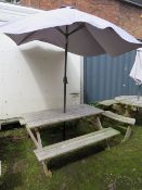 A ROWINSON WOODEN GARDEN / PATIO TABLE WITH PARASOL AND STAND