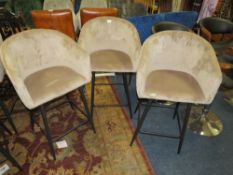 A SET OF THREE TAUPE UPHOLSTERED KITCHEN STOOLS