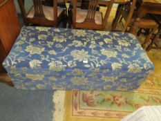 A MODERN BLUE UPHOLSTERED OTTOMAN