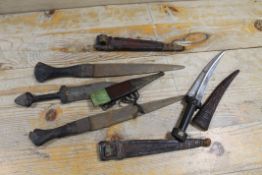 A 19TH CENTURY ISLAMIC MIDDLE EASTERN KURDISH KNIFE WITH CURVED BLADE AND TOOLED LEATHER SHEATH