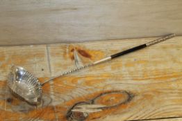 A VINTAGE CONTINENTAL SILVER LADLE WITH EBONISED HANDLE