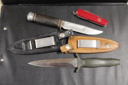 A GERMAN SOLINGEN HUNTING KNIFE & SCABBARD. PLUS A HUNTING KNIFE & LEATHER SCABBARD PLUS A SWISS
