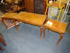 A WALNUT GLASS TOPPED NEST OF TABLES