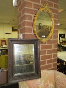 A MODERN GILT OVAL MIRROR AND A CARVED OAK MIRROR (2)